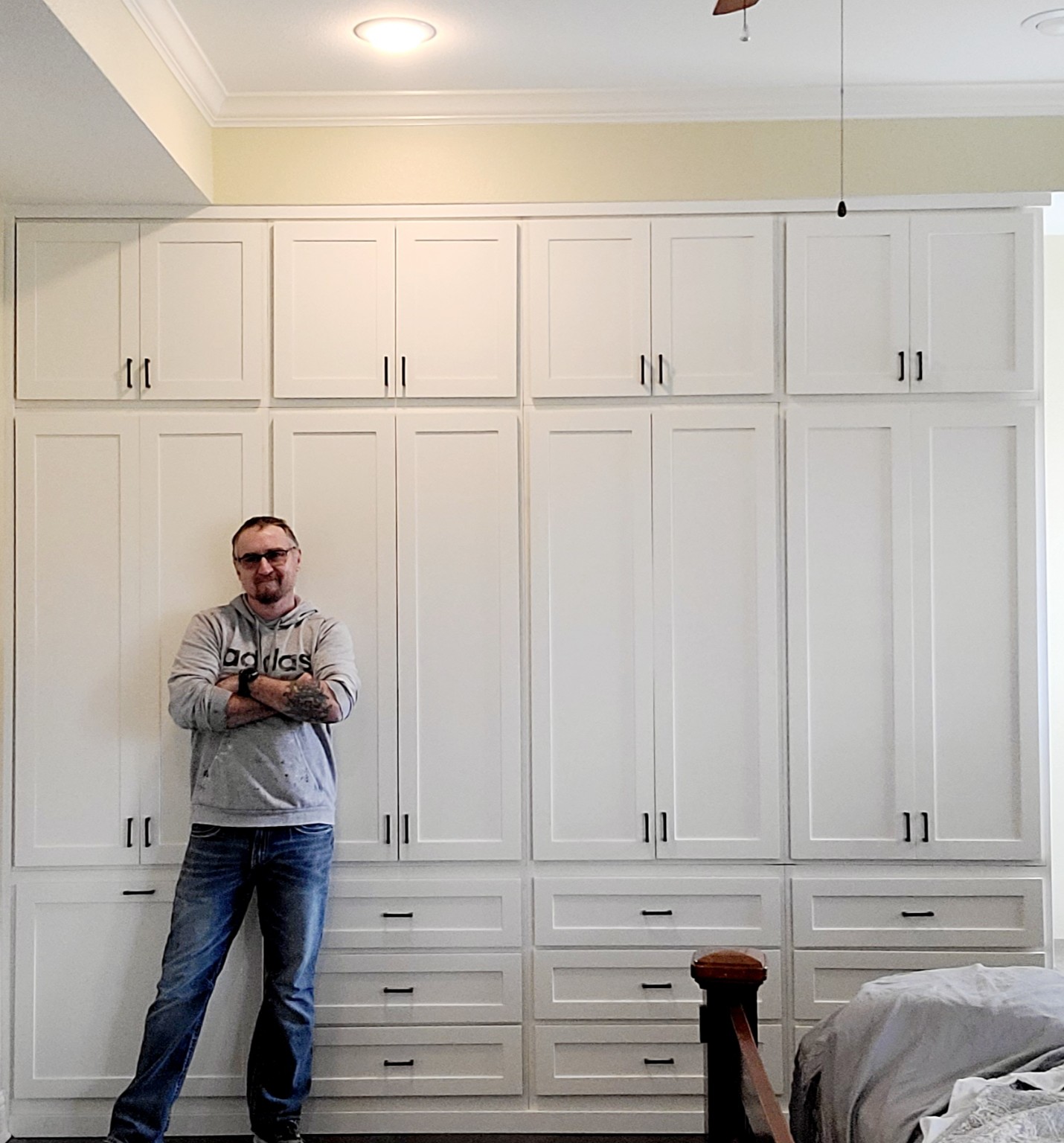 Cabinetmaker Christopher Webb standing in front of custom white cabinetry