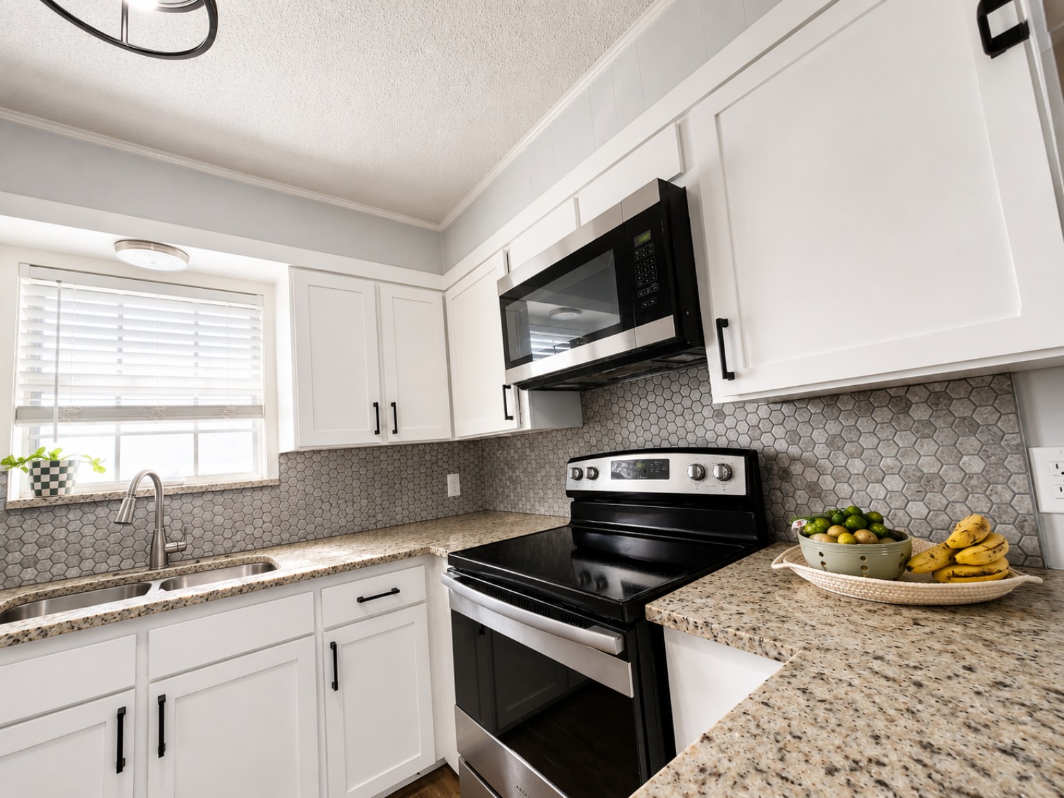 Close view of white Shaker cabinet doors surrounding a range