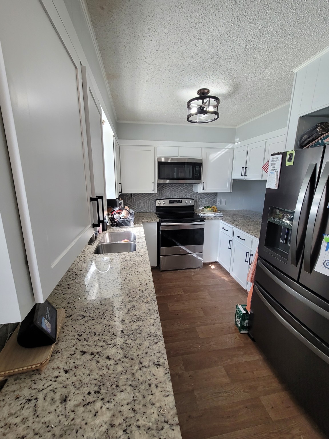 Wide view of a finished white cabinet kitchen